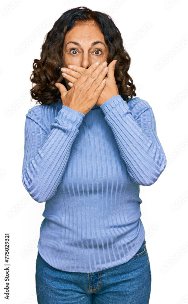 Middle age hispanic woman wearing casual clothes shocked covering mouth with hands for mistake. secret concept. Middle age hispanic woman wearing casual clothes shocked covering mouth with hands for mistake. secret concept.