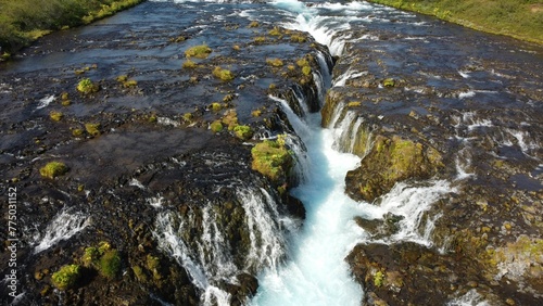 Beautiful view of the Bruarfoss waterfalls on a sunny day in Brekkuskogur, Iceland photo