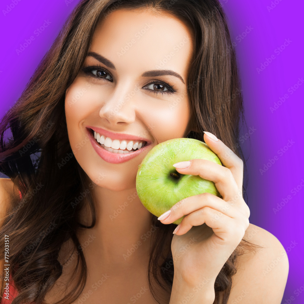 Portrait of toothy smiling happy woman with white teeth hold apple, isolated over against violet purple background. Brunette girl - optimistic, positive, dieting dental care, stomatology ad concept. Portrait of toothy smiling happy woman with white teeth hold apple, isolated over against violet purple background. Brunette girl - optimistic, positive, dieting dental care, stomatology ad concept.