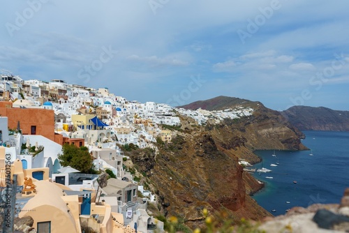 Greek village on the volcanic cliffs of Santorini © Wirestock