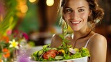 Woman in straw hat with fresh salad bowl smiling