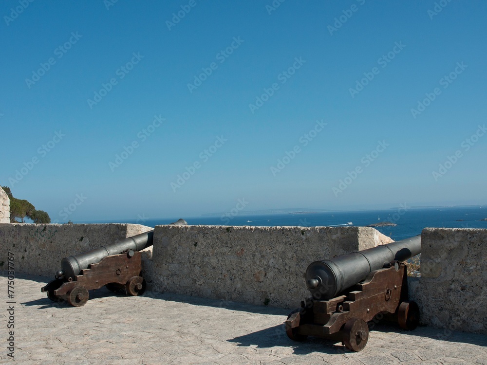 Old cannons on the top of a fortress by the Mediterranean sea in Ibiza, Spain