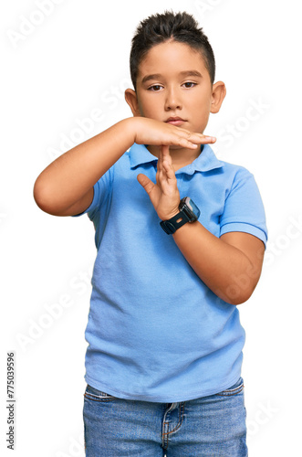 Little boy hispanic kid wearing casual clothes doing time out gesture with hands, frustrated and serious face