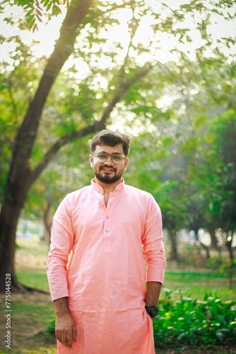 Portrait of Cheerful Happy handsome indian man looking in front of the camera. Indian man in traditional wear or kurta pyjama cloths 