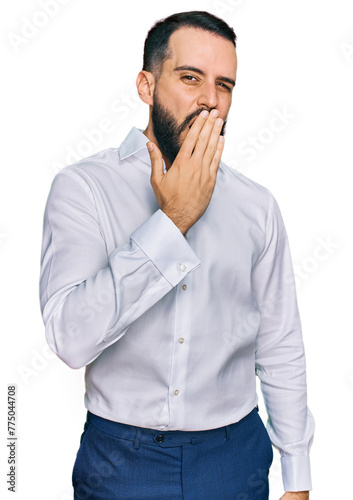 Young man with beard wearing business shirt bored yawning tired covering mouth with hand. restless and sleepiness. © Krakenimages.com