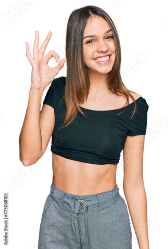 Young brunette woman wearing casual clothes smiling positive doing ok sign with hand and fingers. successful expression.