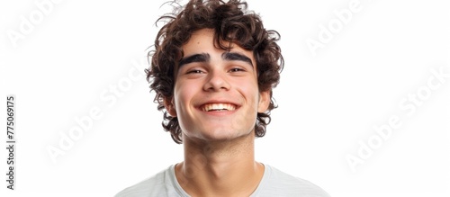Smiling male with curly hair and white shirt