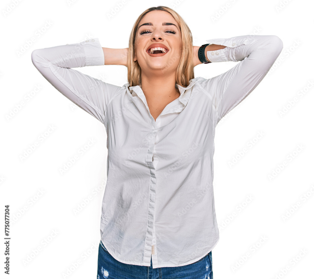 Young caucasian woman wearing casual clothes relaxing and stretching, arms and hands behind head and neck smiling happy Young caucasian woman wearing casual clothes relaxing and stretching, arms and hands behind head and neck smiling happy
