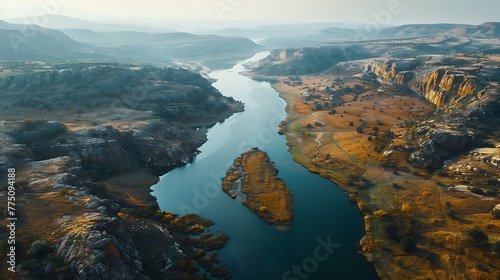 An aerial view of a winding river carving through rugged canyon terrain