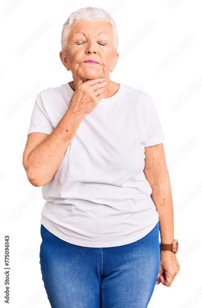 Senior beautiful woman with blue eyes and grey hair wearing casual white tshirt touching painful neck, sore throat for flu, clod and infection Senior beautiful woman with blue eyes and grey hair wearing casual white tshirt touching painful neck, sore throat for flu, clod and infection