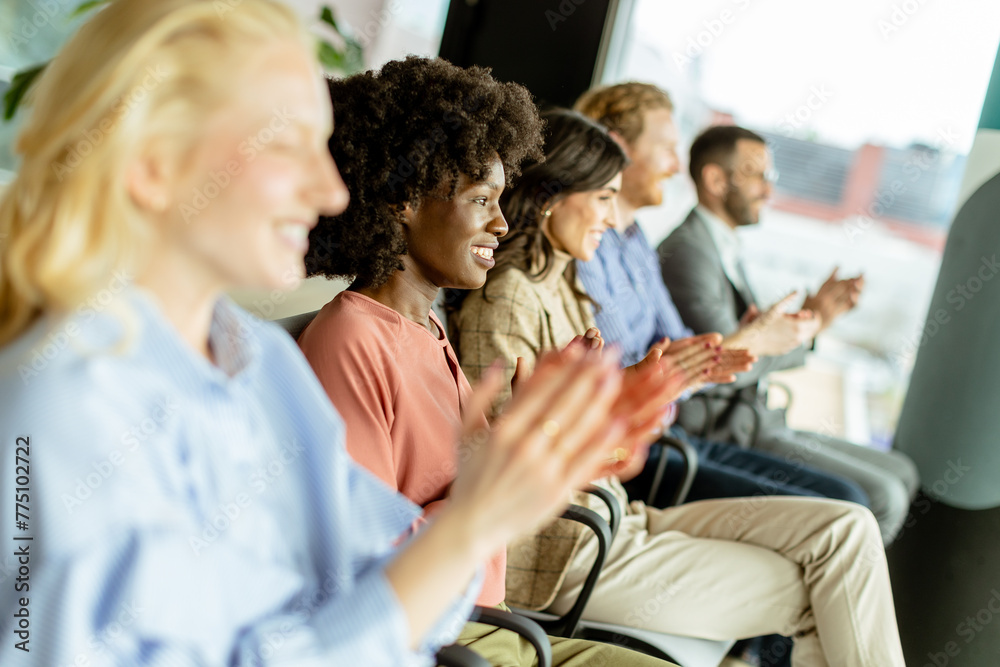 Energetic applause by a diverse group at a casual indoor event Energetic applause by a diverse group at a casual indoor event