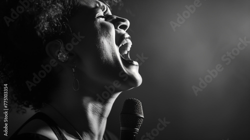 A black and white photo capturing the emotion on a woman's face as she sings her heart out