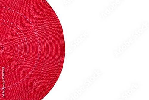White background of red and white ribbon wound in a circle © Valeria F