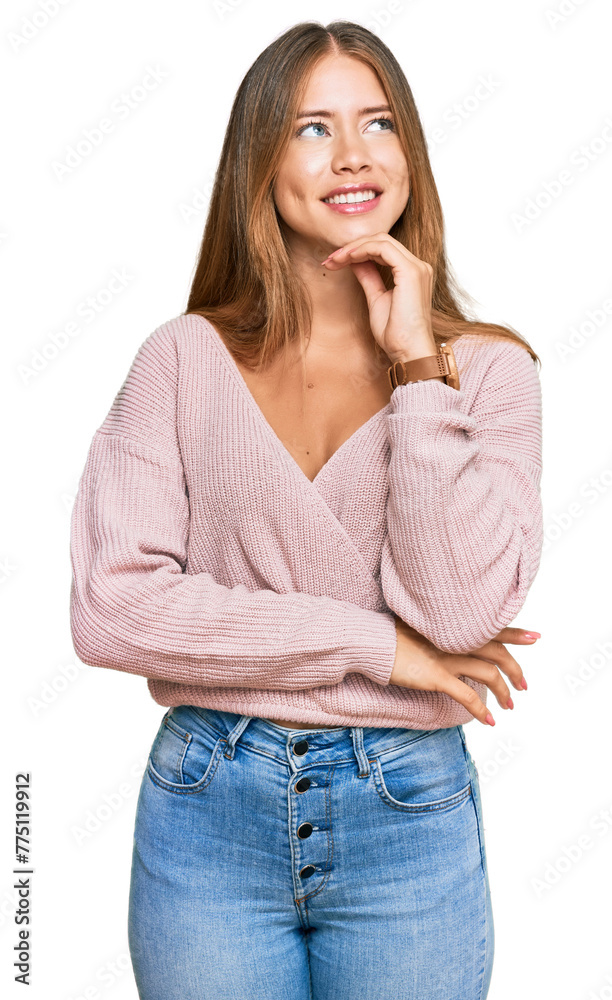 Beautiful blonde woman wearing casual winter pink sweater with hand on chin thinking about question, pensive expression. smiling and thoughtful face. doubt concept. Beautiful blonde woman wearing casual winter pink sweater with hand on chin thinking about question, pensive expression. smiling and thoughtful face. doubt concept.