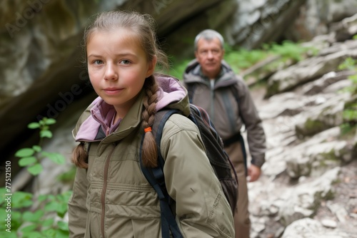 Grandfather with young girl in wilderness, wisdom and youth together, exploring rocky terrain with curiosity. Elderly man accompanies grandchild on a nature walk, guiding her through