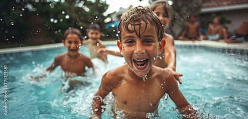 A group of siblings playing a game of tag in the pool, one of them pausing mid-chase to flash a playful, their joy evident in the image © Stone Shoaib