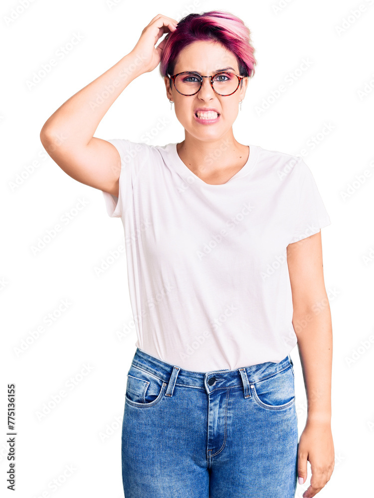 Young beautiful woman with pink hair wearing casual clothes and glasses confuse and wonder about question. uncertain with doubt, thinking with hand on head. pensive concept. Young beautiful woman with pink hair wearing casual clothes and glasses confuse and wonder about question. uncertain with doubt, thinking with hand on head. pensive concept.