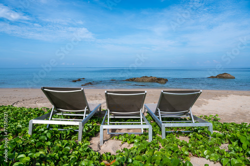 Beach chairs and beach morning glory on the beach at Lanta island, Krabi, Thailand