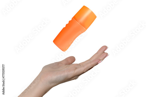 Hand of a young girl on a white background. Orange cosmetic cream.
