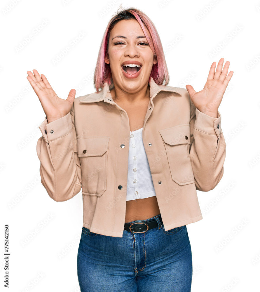 Hispanic woman with pink hair wearing casual clothes celebrating crazy and amazed for success with arms raised and open eyes screaming excited. winner concept Hispanic woman with pink hair wearing casual clothes celebrating crazy and amazed for success with arms raised and open eyes screaming excited. winner concept