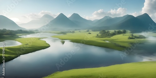 Foggy landscape with river and mountains in the background at sunrise