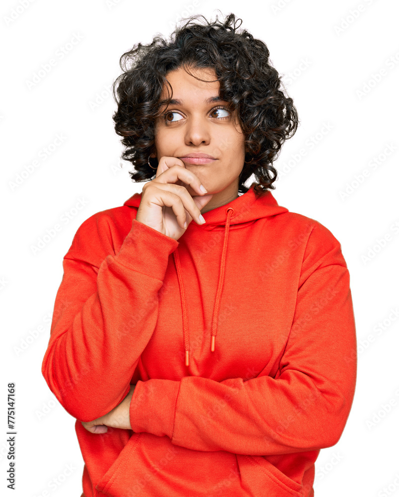 Young hispanic woman with curly hair wearing casual sweatshirt serious face thinking about question with hand on chin, thoughtful about confusing idea Young hispanic woman with curly hair wearing casual sweatshirt serious face thinking about question with hand on chin, thoughtful about confusing idea