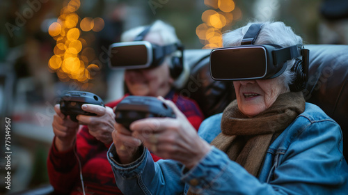 Elderly couple, a man and a woman, sitting at home, play an online game in virtual reality helmets. Seniors have fun playing internet games.