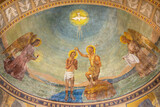 MILAN, ITALY - MARCH 4, 2024: The fresco Baptism of Jesus in the church Chiesa di San Agostino as the copy of early mosaic destructed in WWII from 20. cent.