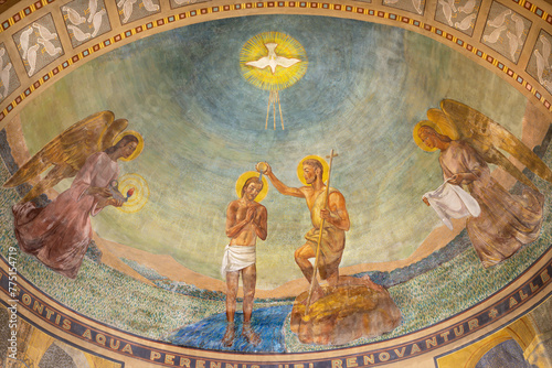 MILAN, ITALY - MARCH 4, 2024: The fresco Baptism of Jesus in the church Chiesa di San Agostino as the copy of early mosaic destructed in WWII from 20. cent.
