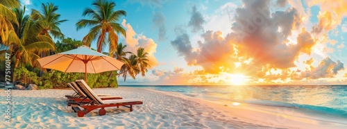 Beach chairs and umbrella on the white sand beach with palm trees, sunset light