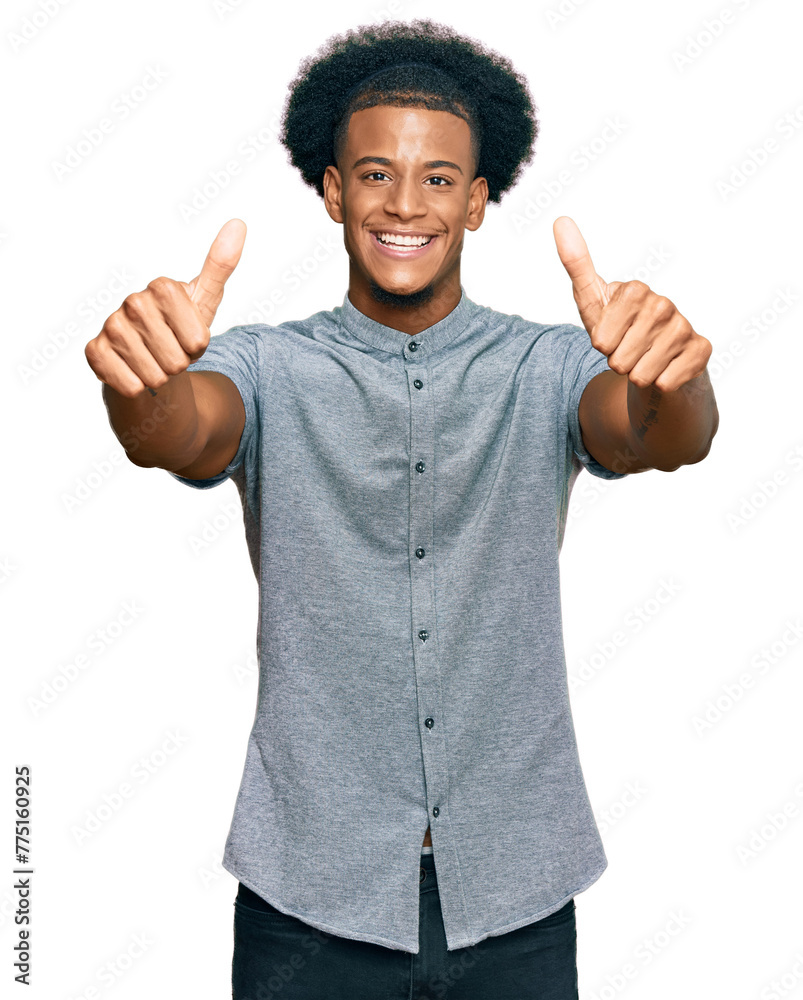 African american man with afro hair wearing casual clothes approving doing positive gesture with hand, thumbs up smiling and happy for success. winner gesture.