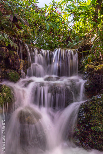 Fototapeta Naklejka Na Ścianę i Meble -  A scenic view of a calmly flowing waterfall.