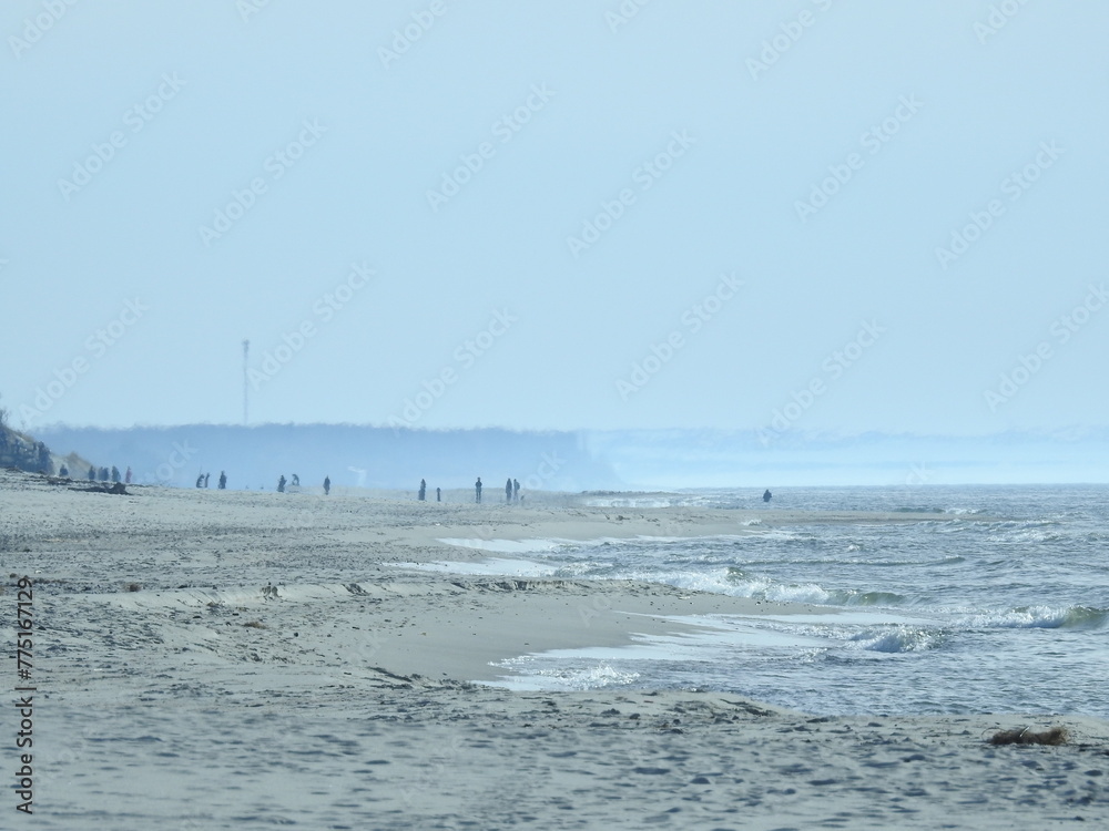 people walking alongside baltic sea