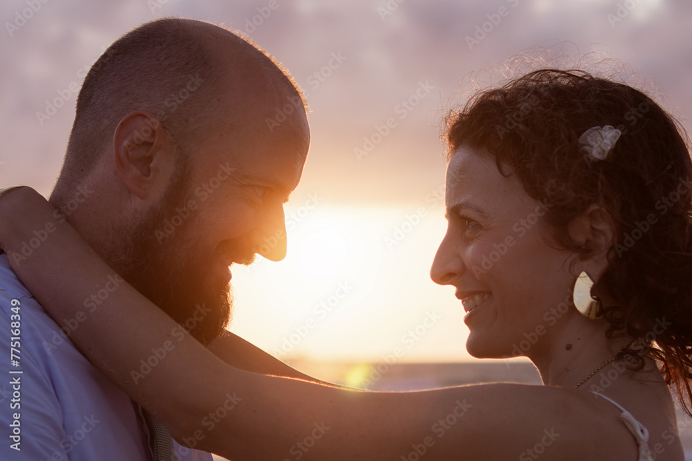 Couple Embracing at Sunset on Beach Couple Embracing at Sunset on Beach