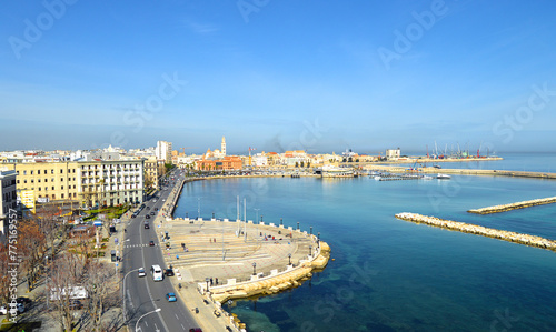 Scenic view of seafront and harbor of Bari, Puglia, Italy. Margherita theater, San Sabino cathedral and fort of Sant'Antonio. Cityscape of Bari at sun