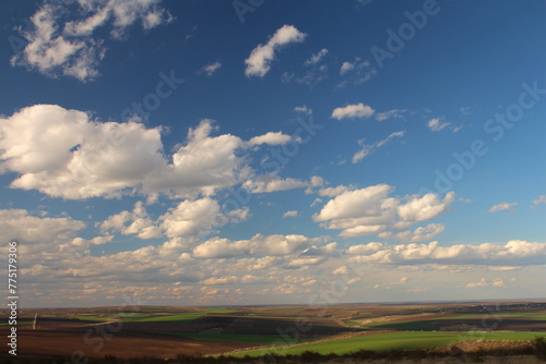 A landscape with a blue sky and clouds