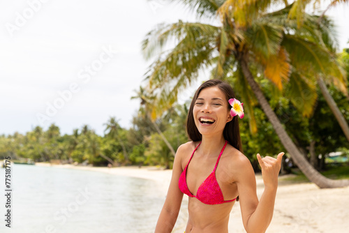 Fun laughing luxury travel beach vacation woman showing Hawaiian shaka sign traditional on Hawaii. Image is unretouched and model is without makeup. Authentic real people. Original Raw Image