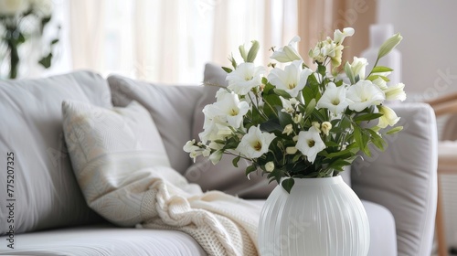 Elegance in simplicity  White vase holds delicate flowers on white  emanating serenity and minimalist beauty.