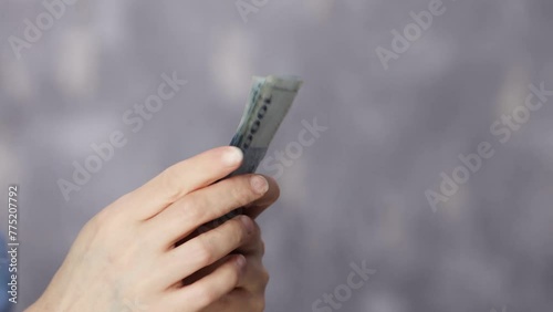 girl's hands counting Korean banknotes
 photo