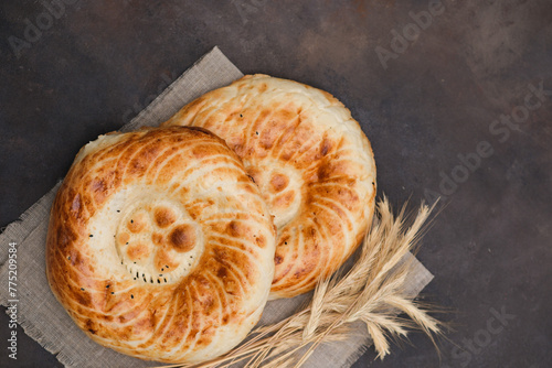 Asian flatbread on brown background, top view. photo