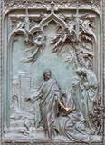 MILAN, ITALY - SEPTEMBER 16, 2024: The detail from main bronze gate of the Cathedral - Annunciation - by Ludovico Pogliaghi (1906).