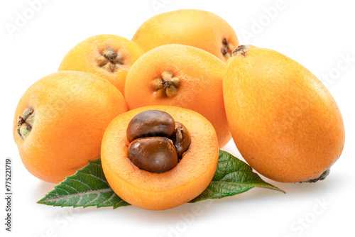 Ripe perfect loquat fruits with green leaves isolated on white background. photo