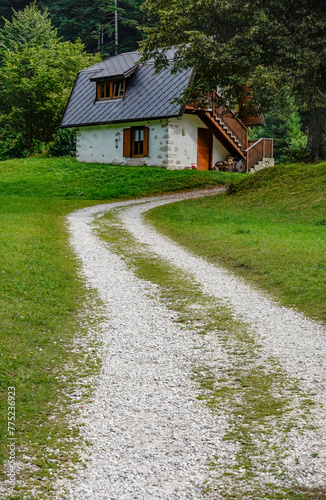 A wooden, cozy cottage house in the forest, Dolomites, Italy 