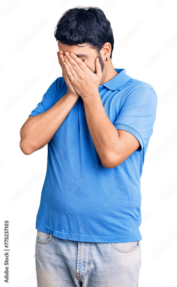 Young hispanic man wearing casual clothes with sad expression covering face with hands while crying. depression concept. Young hispanic man wearing casual clothes with sad expression covering face with hands while crying. depression concept.