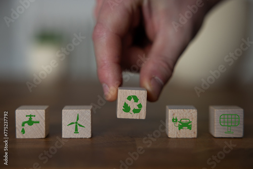 Green and eco building concept. wooden cubes with green building symbols on the natural background. LEED certification. Leadership in Energy and Environmental Design. Sustainable building.