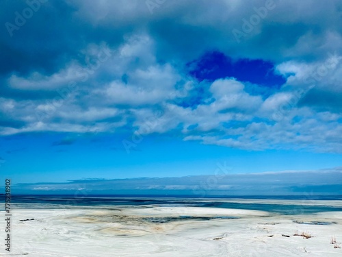 Fototapeta Naklejka Na Ścianę i Meble -  Frozen sea coast, ice at the sea, sea horizon, sky reflection on the water surface, natural colors