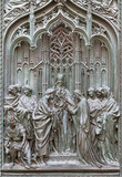 MILAN, ITALY - SEPTEMBER 16, 2024: The detail from main bronze gate of the Cathedral - Spouse of St. Joseph and Virgin Mary - by Ludovico Pogliaghi (1906).