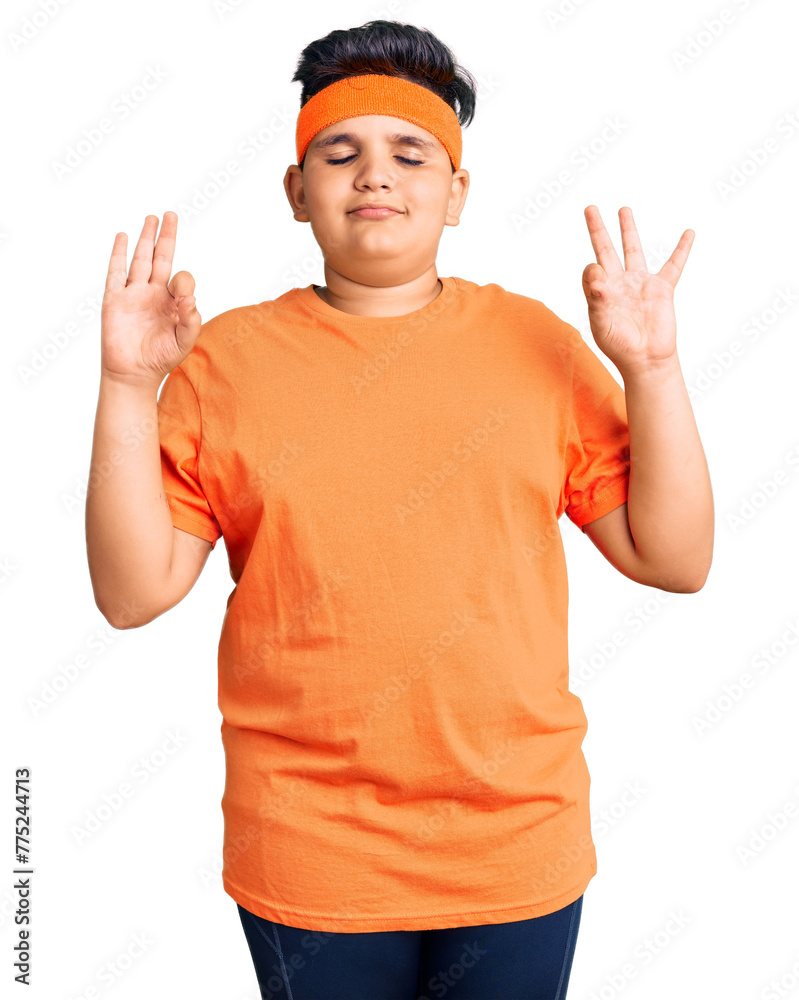 Little boy kid wearing sportswear relaxed and smiling with eyes closed doing meditation gesture with fingers. yoga concept. Little boy kid wearing sportswear relaxed and smiling with eyes closed doing meditation gesture with fingers. yoga concept.