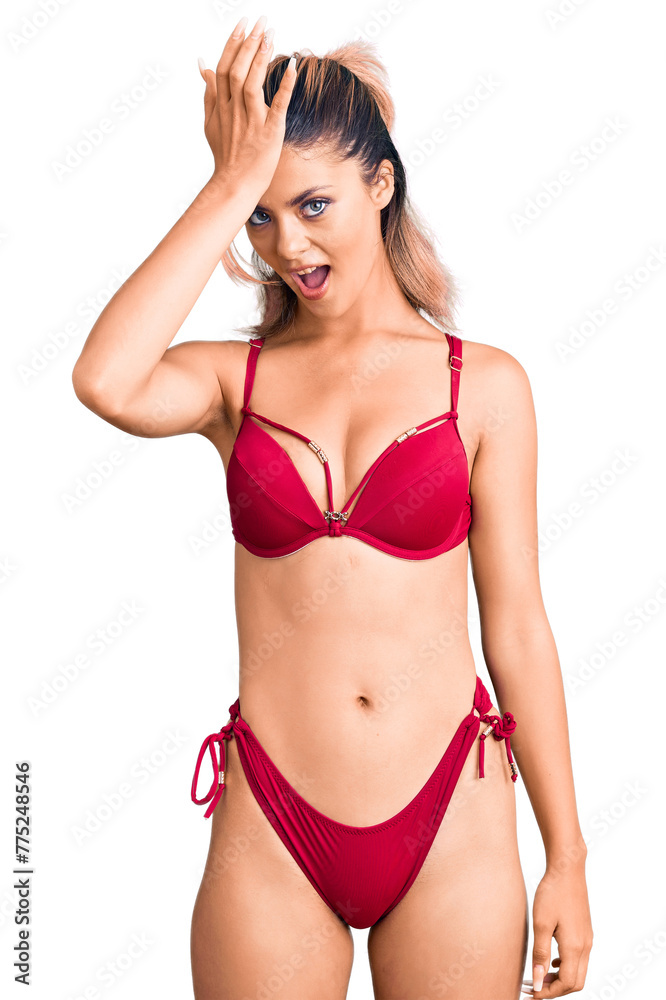 Young beautiful woman wearing bikini surprised with hand on head for mistake, remember error. forgot, bad memory concept. Young beautiful woman wearing bikini surprised with hand on head for mistake, remember error. forgot, bad memory concept.