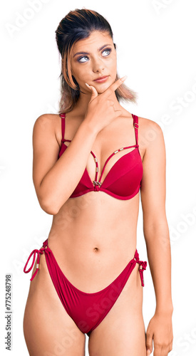 Young beautiful woman wearing bikini thinking worried about a question, concerned and nervous with hand on chin © Krakenimages.com